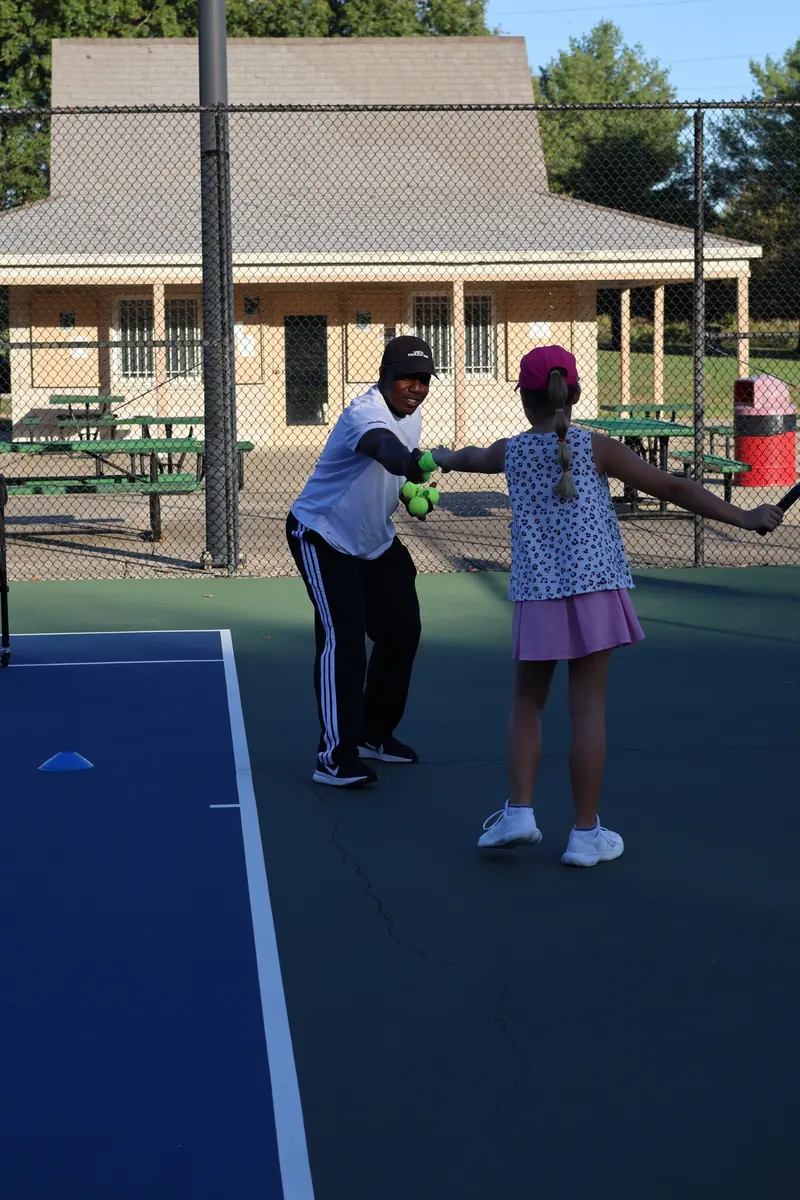 Coach celebrating a good rep with a young player