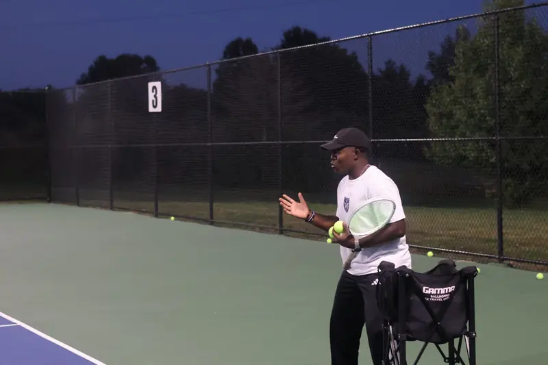 Coach Kuda explaining a technical point during a private lesson
