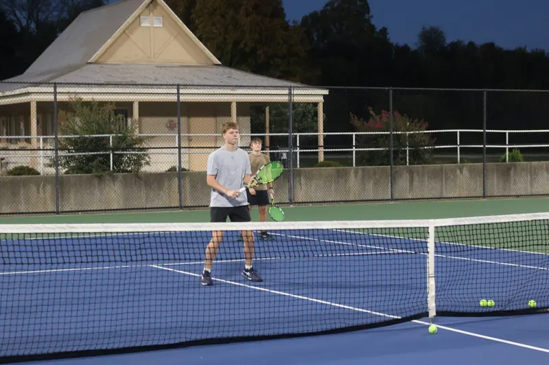 Two players training together at the net during a group session